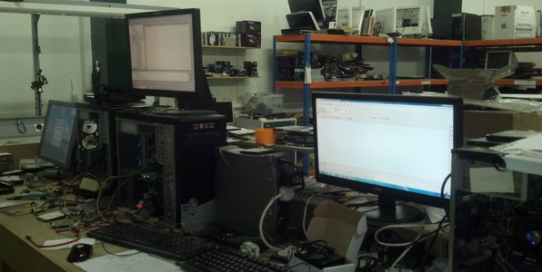 Workbenches with computers and drives being recovered in the London lab